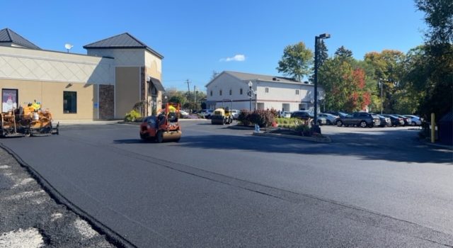 Christopher's Paving workers paving a commercial parking lot