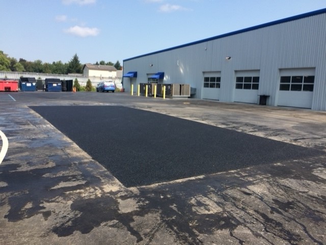 Resurfaced patch of asphalt in a parking lot