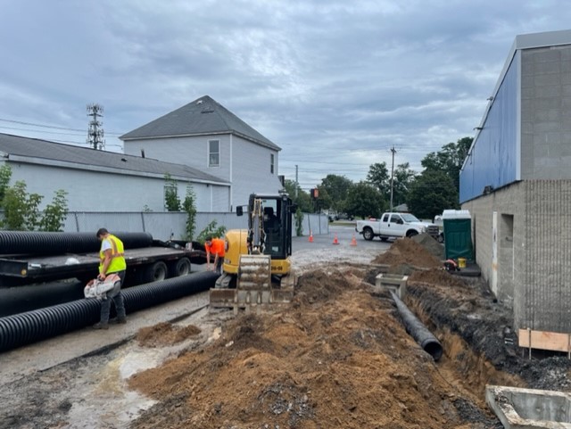 Workers from Christopher's Paving LLC preparing a site for a new paving job