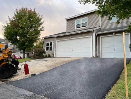 Christopher's Paving working on a residential driveway for an HOA